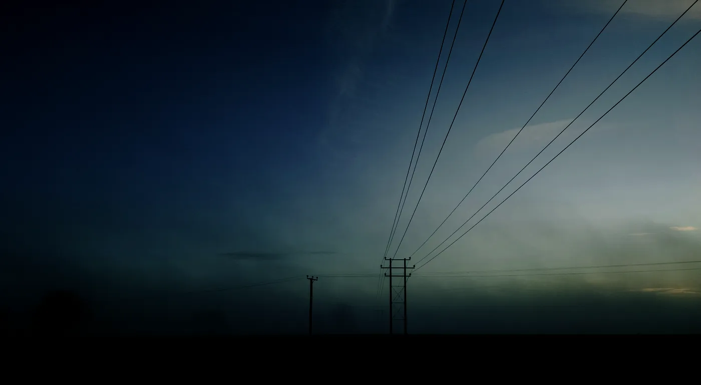 Power lines over a misty field